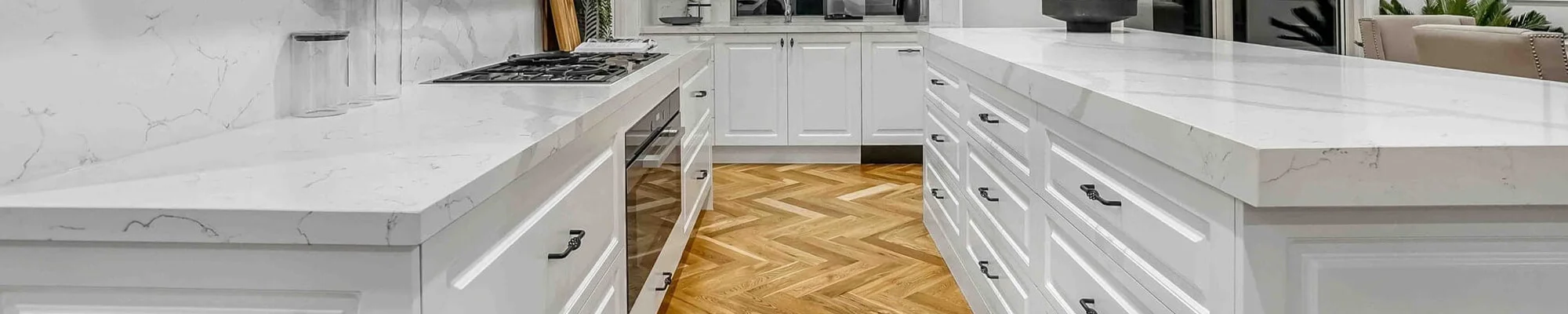 Hardwood flooring in kitchen with white countertops provided by Troy Flooring Center in Troy, MO